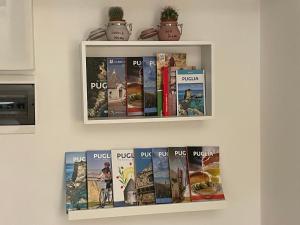 a shelf with books on a wall at URBAN HOME in Bari