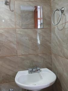a bathroom with a sink and a mirror at Departamento cerca de la playa in Puerto Vallarta