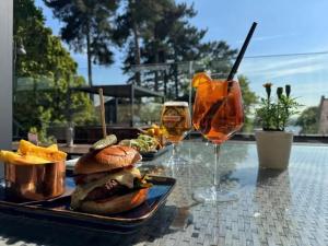 a tray with a sandwich and two glasses of wine at Rutland Hall Hotel & Spa in Burley