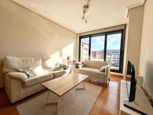 a living room with a couch and a table at Apartamento Olmeca - Monabri in Santander