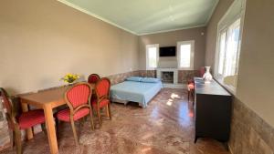 a living room with a table and chairs and a bed at Villa daisy in Rafina