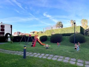 a group of children playing on a playground at Apartamento Olmeca - Monabri in Santander