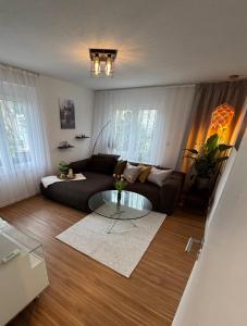 a living room with a couch and a glass table at Schwarzwald Ferienwohnung in Freudenstadt