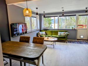 a living room with a couch and a table at Fjord View Cabin Near Bergen & Nature in Grottveit