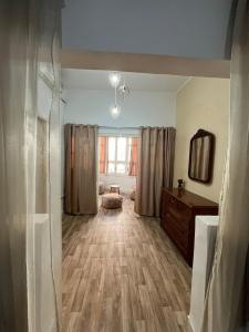 a living room with a dresser and a mirror at Comfy Beachfront ground floor apartment in le Kram in Al Karm