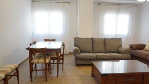 a living room with a couch and a table and chairs at Apartamento La Pina in Cabezuela del Valle