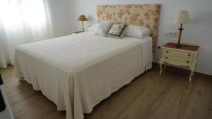 a bedroom with a bed and a table with a nightstand at Apartamento La Pina in Cabezuela del Valle