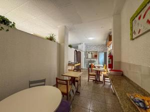 a room with tables and chairs in a restaurant at Hotel Daniel Elohim in São Paulo