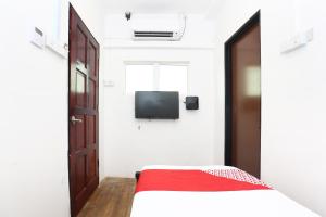 a bedroom with a bed and a tv on the wall at Hotel O Ady Hotel in Kuala Terengganu +35 photos