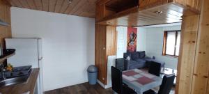 a kitchen with a sink and a table in a room at Chaleureux logement in Calais