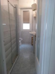 a bathroom with a toilet and a sink and a window at Vista dall' Eden in Mortola Superiore +42 photos