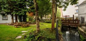 a garden with a picnic table and a pond at Mercure Perth Hotel in Perth