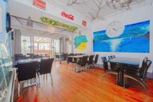 a restaurant with tables and chairs in a room at Pier Hotel Clacton on Sea By OYO in Clacton-on-Sea