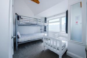 a bedroom with two bunk beds and a window at Pier Hotel Clacton on Sea By OYO in Clacton-on-Sea