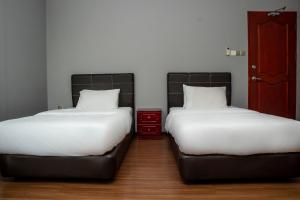 Postel nebo postele na pokoji v ubytování OYO 90059 Ltk Home