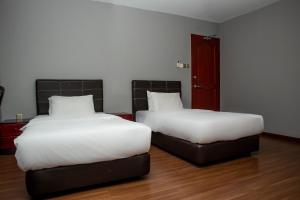 Postel nebo postele na pokoji v ubytování OYO 90059 Ltk Home
