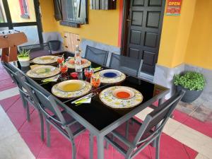 a table with plates and chairs on a patio at La Casa di Gio ed Eli in Voghera +80 photos
