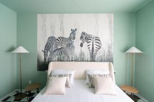 a bedroom with a bed with zebras on the wall at Jungle Apartment in Schio