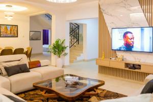 a living room with a couch and a tv at Casa Eko in Lekki