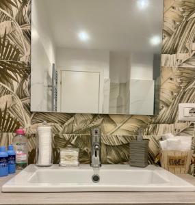 a bathroom with a sink and a mirror at Karma apartment in Catania