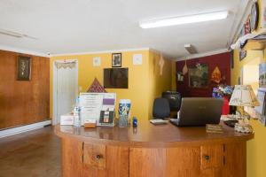an office with a desk with a laptop on it at BlueJay Motel - Salem - Roanoke I-81 in Salem