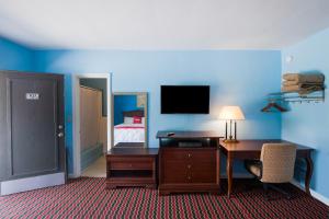 a hotel room with a desk and a bed at BlueJay Motel - Salem - Roanoke I-81 in Salem +18 photos