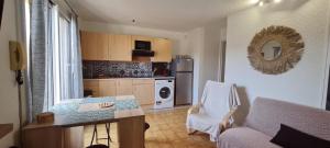 a kitchen with a couch and a table in a room at Appartement Ste Maxime in Sainte-Maxime +3 photos