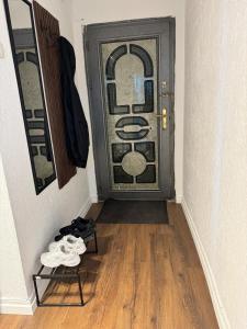 a door in a hallway with a pair of shoes at ApartmentGjilanCenter in Gnjilane +18 photos