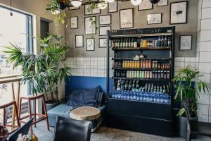 a room with a shelf filled with bottles of beer at Domus Metro Hotel in Tel Aviv