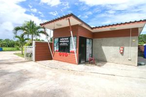 a small building with a sign in front of it at The Rome Resort in Pran Buri