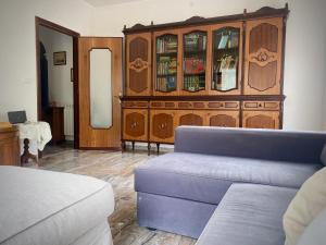 a living room with a couch and a wooden cabinet at Spacious Apartment with Air Conditioning in Ranzo-Borgo