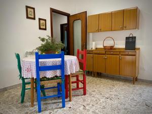 a kitchen with a table with colorful chairs and a counter at Spacious Apartment with Air Conditioning in Ranzo-Borgo