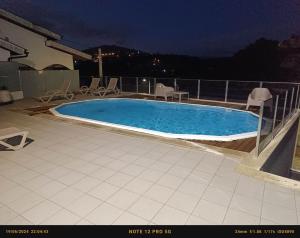 a swimming pool on top of a house at night at Douro VALLEY- Casa da Madrinha in Escamarão