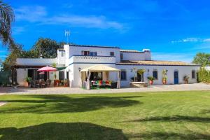 a large white house with a grass yard at Elegant Villa in Loulé with Private Pool in Loulé