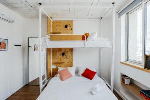 a small room with a bed and bunk beds at Domus Metro Hotel in Tel Aviv +88 photos