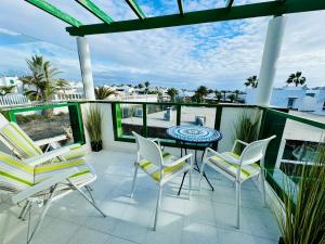 a patio with a table and chairs on a balcony at Little Gem in Matagorda