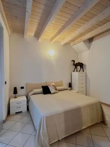 a bedroom with a bed and a horse statue on a dresser at Rossi Lake Family in Oliveto Lario