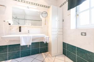 a bathroom with a sink and a mirror at Parkvilla 11 in Fürstenfeld +64 photos
