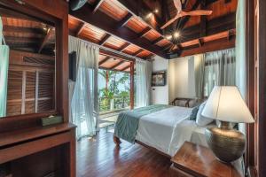 a bedroom with a bed and a large window at Villa Gecko with sea view pool, walk to Beach & Restaurants in Surin Beach +83 photos