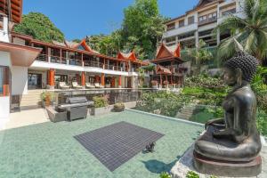 a statue in the courtyard of a building at Villa Gecko with sea view pool, walk to Beach & Restaurants in Surin Beach