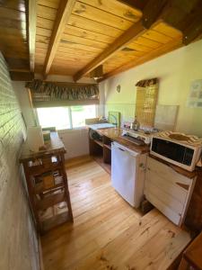 a kitchen with a stove and a sink in it at Cabaña Soñada - Piscina - Jacuzzi in Sierra de los Padres