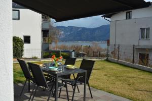 a table and chairs on a patio with a view at Villa Elisabetta in Pergine Valsugana