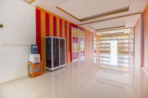 een hal met rode en geel gestreepte muren bij Restu Inn in Lampung