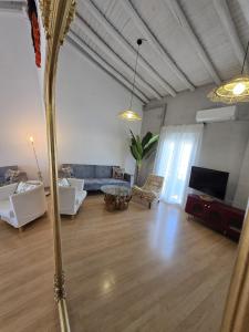 a living room with a blue couch and a tv at Urban Loft - La Conce in Cáceres