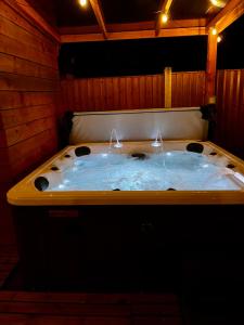 a jacuzzi tub in a room with lights at Town House with Jacuzzi & Sauna in Nottingham +15 photos