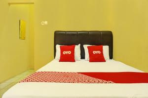Ένα ή περισσότερα κρεβάτια σε δωμάτιο στο Hotel O Sweet Candy 1 Syariah