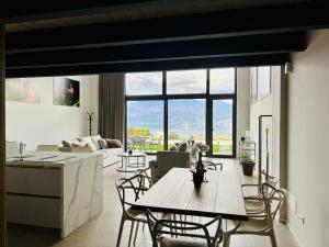 a kitchen and living room with a table and chairs at Panorama Loft Apartments in Stresa
