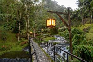 a lantern hanging over a bridge over a river at COMODO ESTUDIO VIA A TERMALEs in Santa Rosa de Cabal