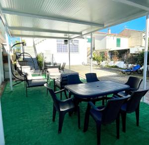 a patio with a table and chairs under a canopy at Alojamento Local Afonso in Macedo de Cavaleiros