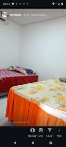 a page of a website with two beds in a room at Chalé ponta verde in São José de Ribamar